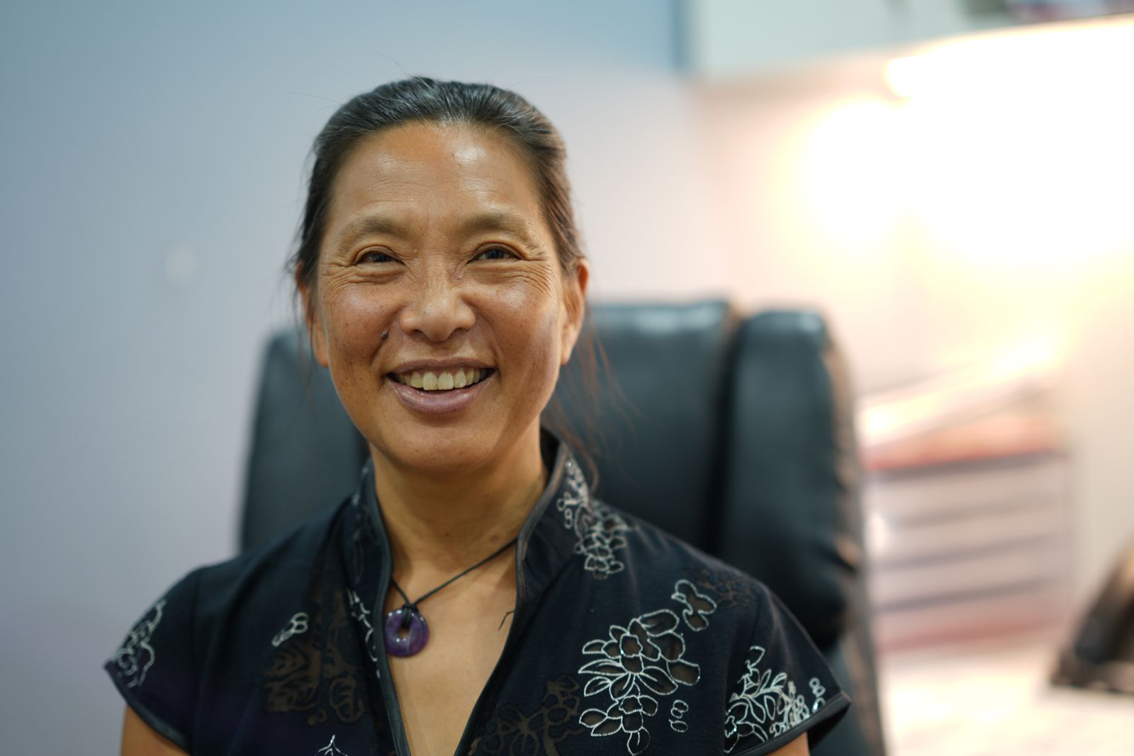 A doctor smiling in her consulting room at Salamander Bay Doctors